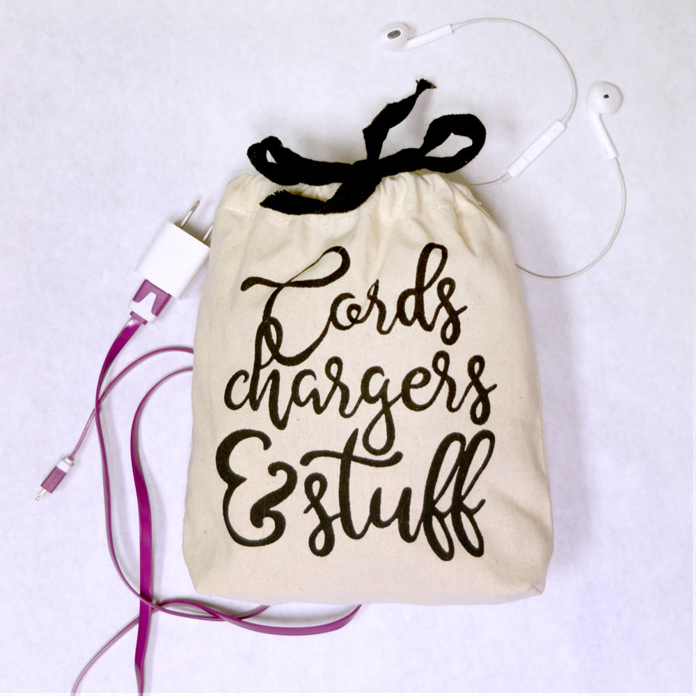 canvas bag with cords, chargers and stuff cursive